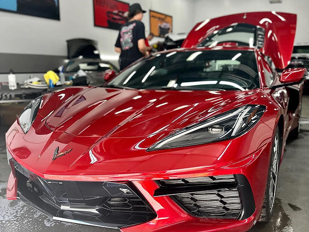 Glossy red sports car after ceramic coating by Mint Mobile Detail